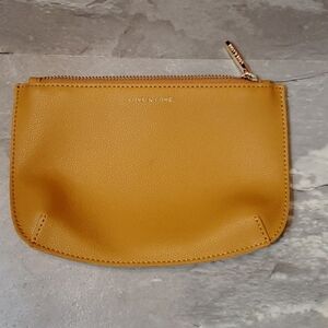 NWOT Love & Lore small thin zip pouch. Vegan leather (faux). Tan/mustard yellow.
